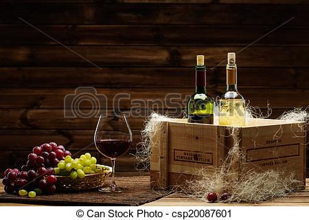 Bottles of red and white wine, glass and grape on a wooden interior